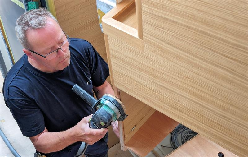 A cabinet is finely sanded to ensure a perfect fit - photo © Mark Jardine